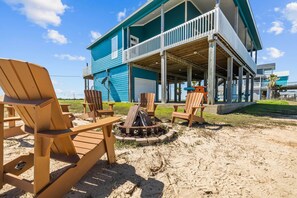 Relax in style with a fire pit and Adirondack chairs on the spacious outdoor area, offering scenic views.