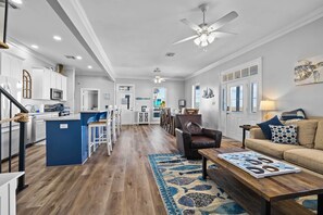 Relax in this stylish living space with a central island, comfortable sofa, and cozy chair.
