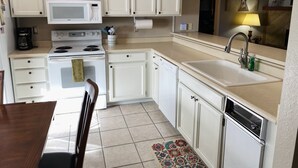 A kitchen with white cabinets, a microwave, stove, sink, and a dishwasher. - Family Friendly Pines Condo-3b/2b (Pinetop-Lakeside)