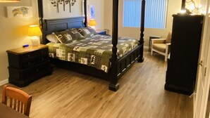 A bedroom with a four-poster bed, a wooden dresser, a desk, and a chair. - Family Friendly Pines Condo-3b/2b (Pinetop-Lakeside)
