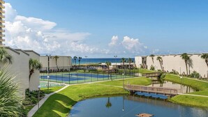 A resort with a pool, a small water feature, and a view of the ocean. - 2BR/2BA Beach front Sleep8 Balcony-Gated Community (Panama City Beach)