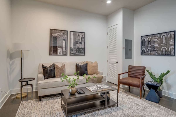 Open concept living room complete with designer furnishings and smart TV.