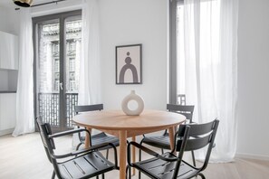 Cozy room with a round table, four chairs, and a framed picture on the wall.