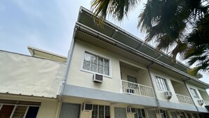 A two-story building with a balcony, multiple windows, and a door. - Lawton Residences powered by Cocotel (Taguig)