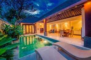 A modern house with a swimming pool, outdoor seating, and a well-lit interior. - Nomad Hub Canggu-Bali (Kerobokan)