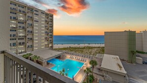 A hotel with a rooftop pool, beach view, and multiple balconies. - Pinnacle Port A533 (Panama City Beach)