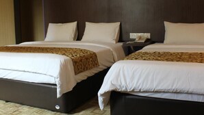 A hotel room with two beds, each with white bedding and a patterned throw. - Hotel Rosmerah (Malacca City)