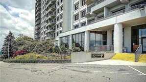 A multi-story building with a modern architectural style, featuring balconies and large windows. - 2-bedroom condo near Sugar Mountain Resort (Sugar Mountain)