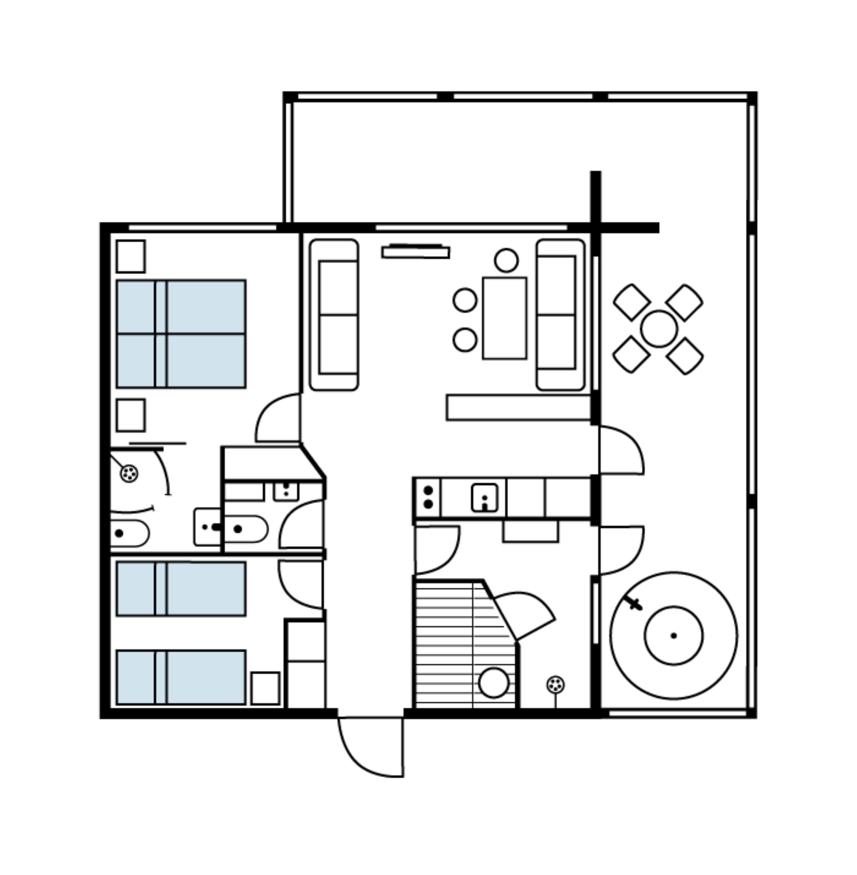 Un plano de planta que muestra una sala de estar, cocina, comedor y una zona de estar circular.