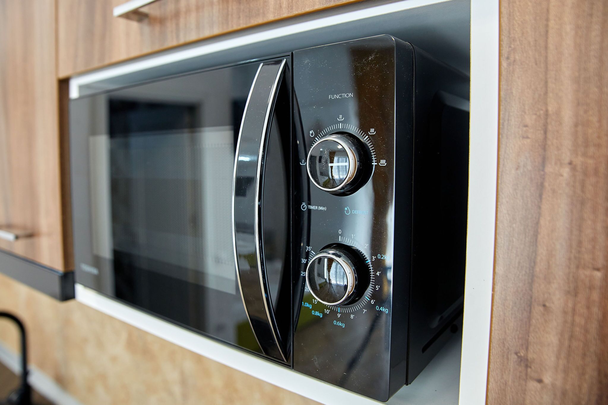 A modern kitchen with a built-in microwave.