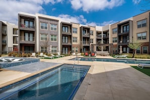 A modern apartment building with a swimming pool, outdoor seating, and a pergola. - MCK203 - Apt|Patio|15mi to Toyota Stadium|Sleeps 4 (McKinney)