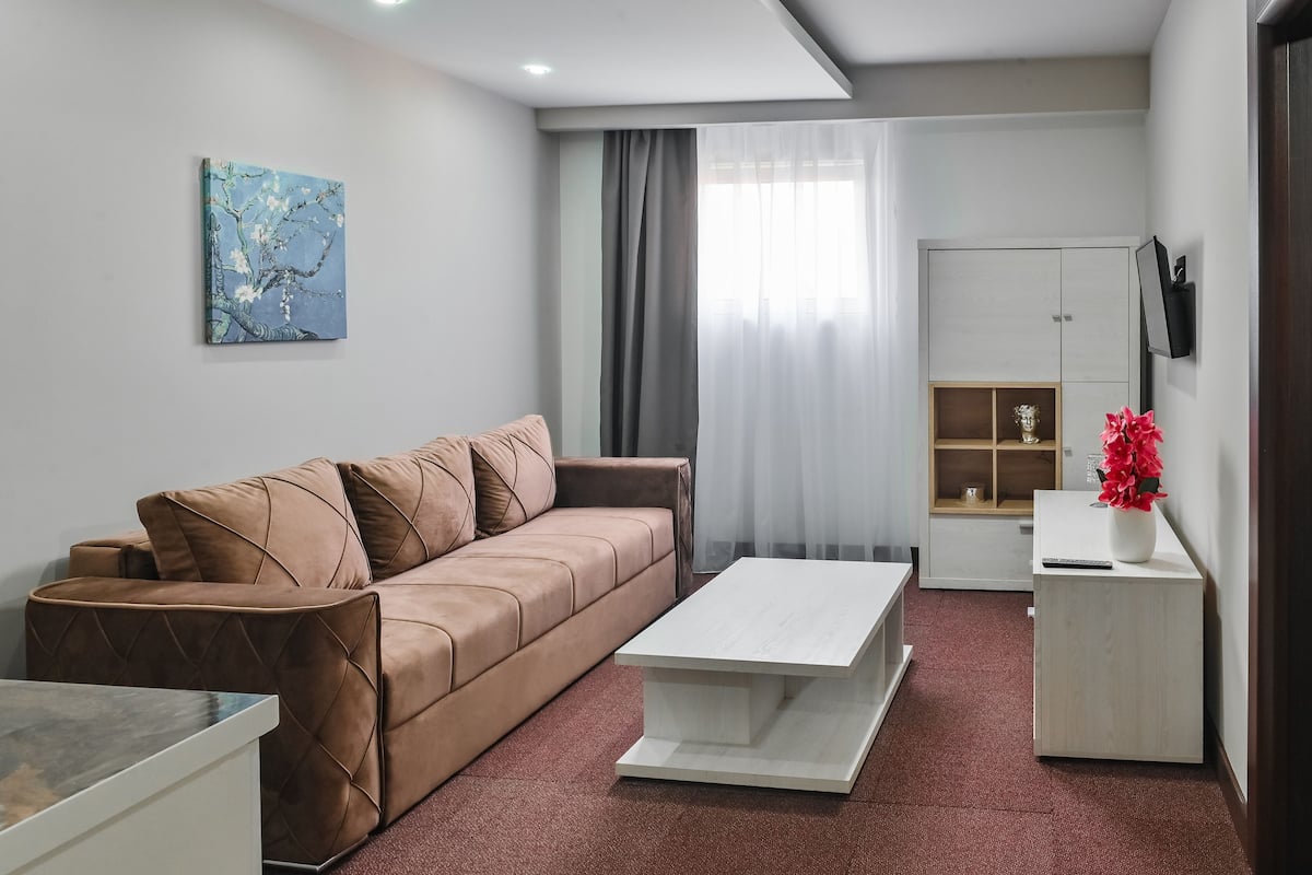 Luxury Apartment | Living area | 32-inch Smart TV with cable channels, TV, heated floors