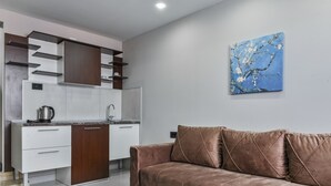 Luxury Apartment | Living area | 32-inch Smart TV with cable channels, TV, heated floors