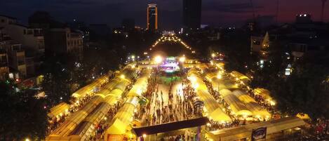 A large outdoor market with numerous stalls and a central stage.