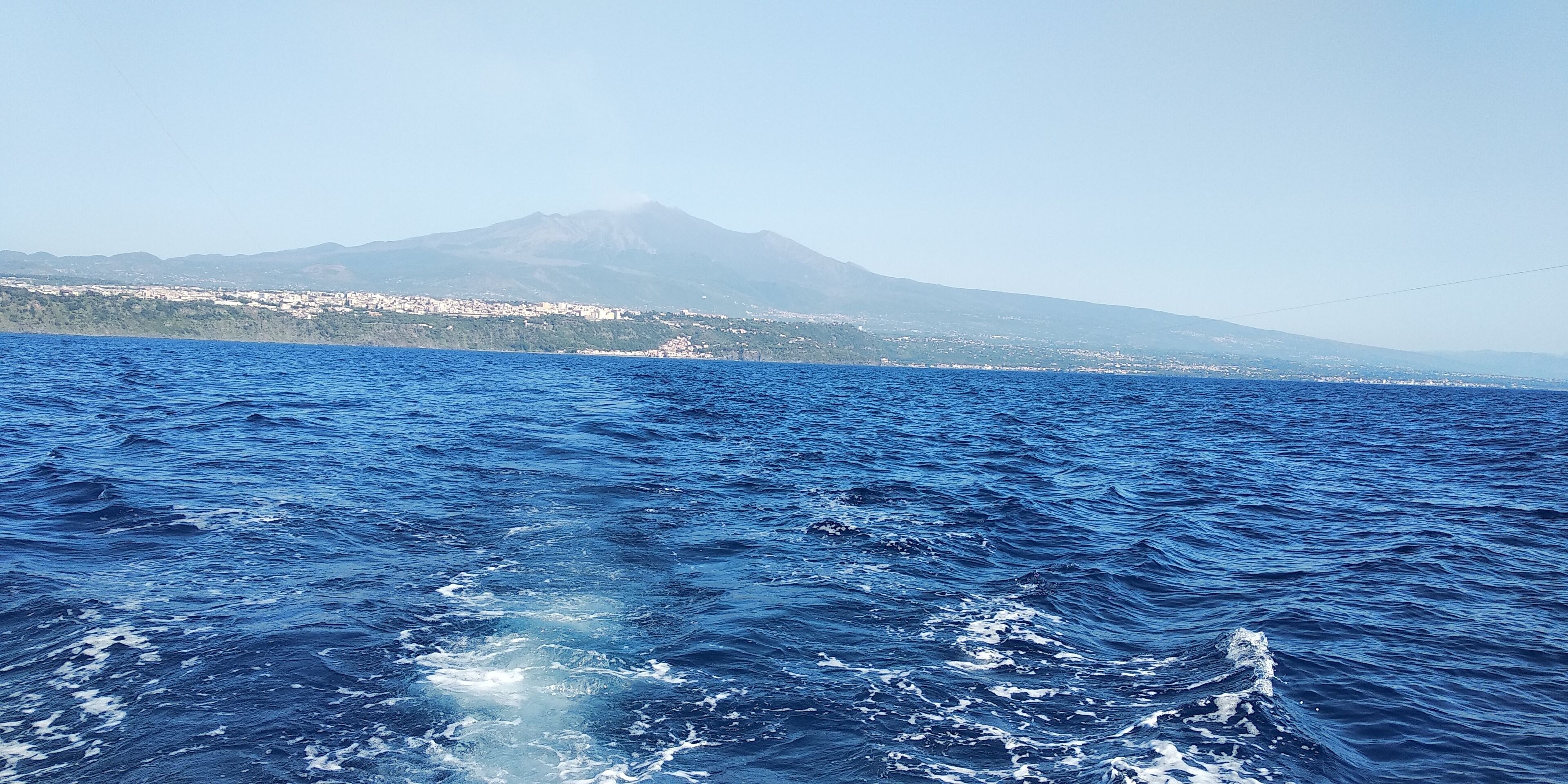 A view of the ocean with a distant mountain range.
