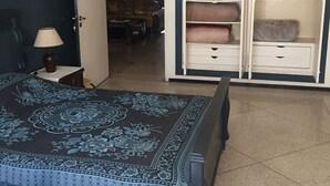 A bedroom with a bed, a wardrobe, a nightstand, and a lamp. - Room-property Located in a Quiet Area cl (Casablanca)