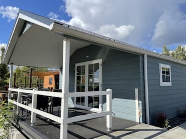 A modern house with a covered porch and a garage.