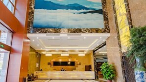 A hotel lobby with a reception desk, a large wall mural, and a chandelier. - Greentree Inn Taian High Speed Railway Station Lingshan Street (Tai'an)