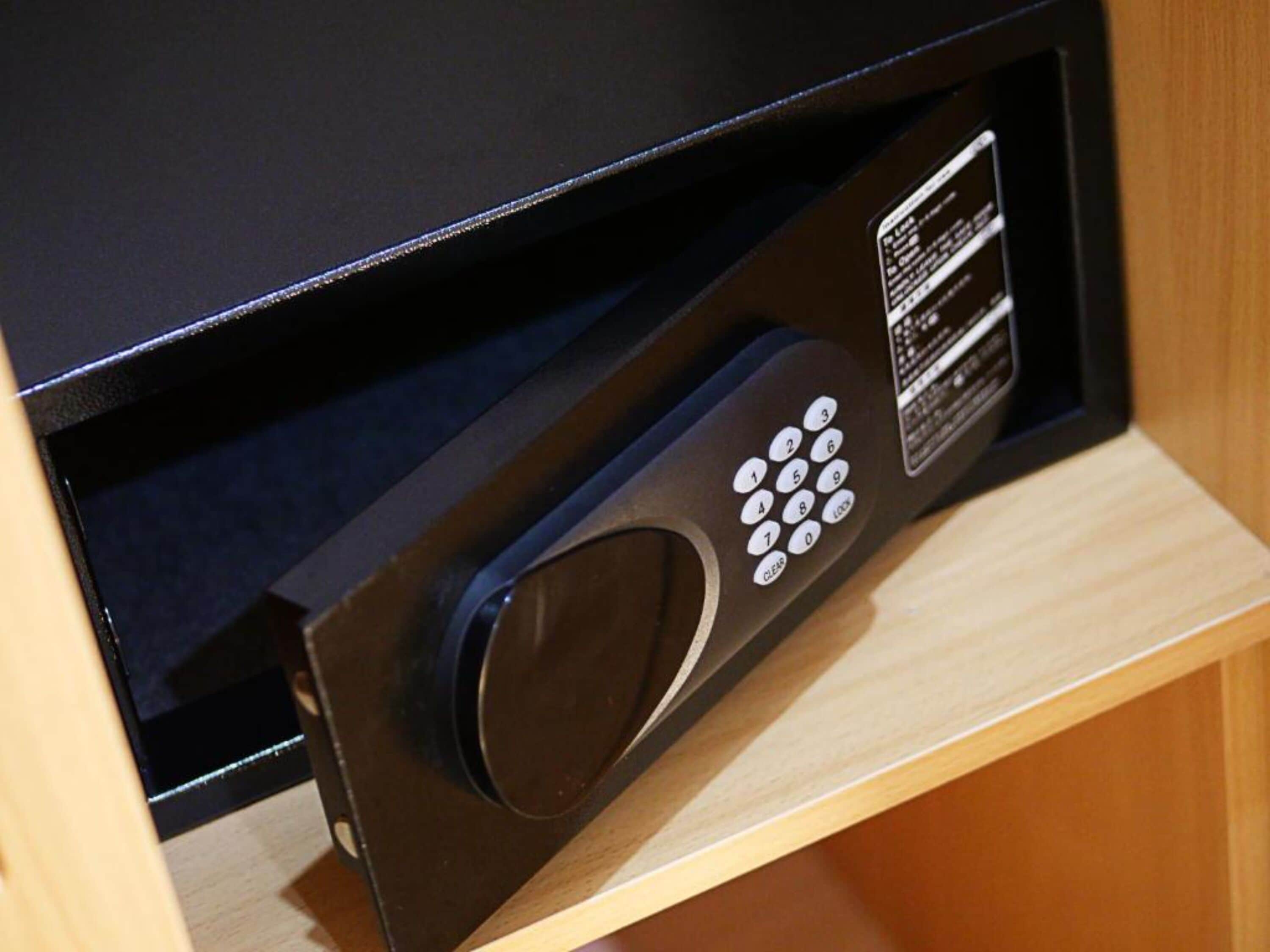 A microwave with a digital display and keypad, housed in a wooden cabinet.
