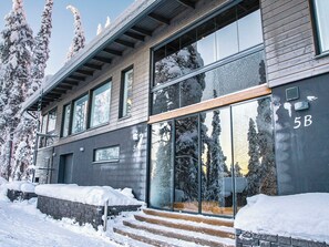 A modern building with large windows and a wooden staircase leading to the entrance. - Rukan rinnemaa a by Interhome (Kuusamo)