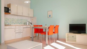 A compact living space with a kitchenette, dining area, and a TV. - Apartment Ivana by Interhome (Senj)