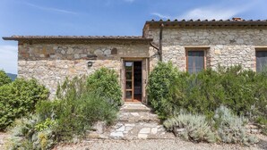 A stone building with a tiled roof, a wooden door, and a stone pathway leading to the entrance. - Lavanda, Montebuoni, Gaiole in Chianti, Siena and Chianti (Gaiole in Chianti)