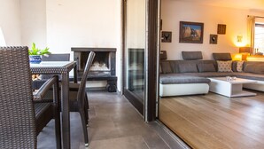 A modern living room with a sofa, a coffee table, and a fireplace.