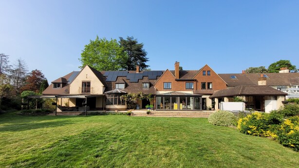 A large house with a spacious lawn, a covered patio, and a garage. - Remarkable 8 Bed Family House Sleeping 16 w/ Pool (Farnborough)