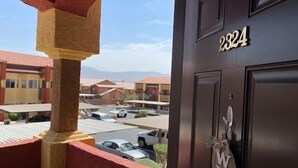 A view from a balcony with a door labeled "2324" and a welcome sign. - Desert Ridge Retreat by Mesquite Vacation Rentals with Pet Friendly Amenities and $510 in free daily activities (Mesquite)