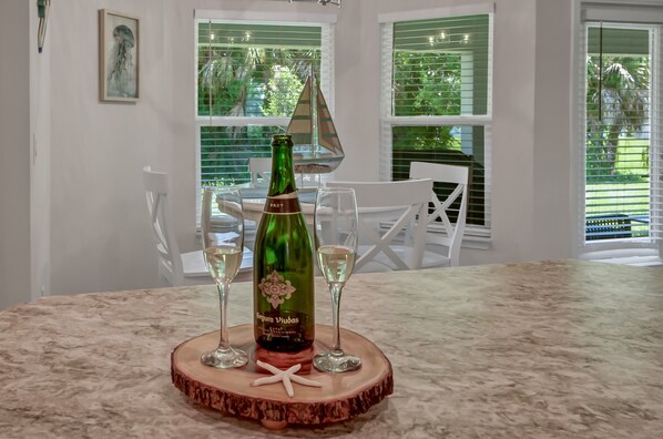 A bottle of Segrua Viudas wine on a wooden coaster with two glasses on a marble table. - Stunning Coastal Retreat, Built 2022 - Casa Mar (Sebastian)