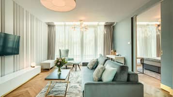 Una sala de estar moderna con sofá, mesa de centro y televisor.