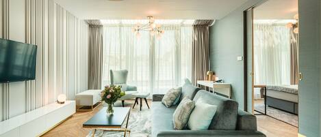 A modern living room with a sofa, coffee table, and TV.