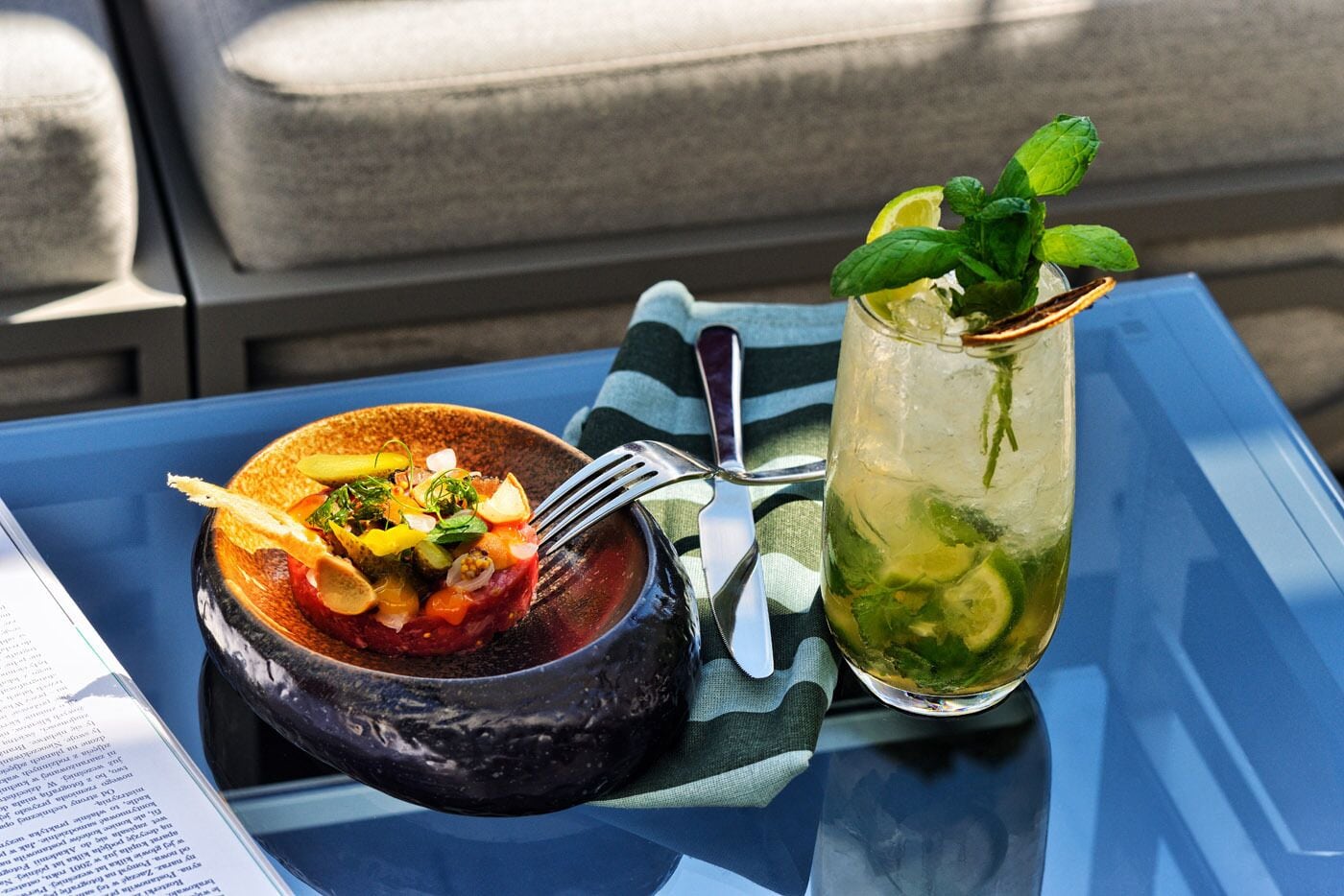 A meal with a bowl and a drink on a table.