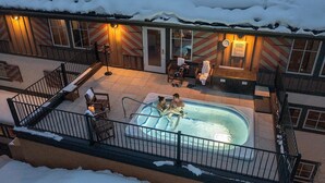 A heated outdoor pool area with a covered seating area and a staircase leading to an upper level. - Lift House Lodge, Pet Friendly Studio Condo (Vail)