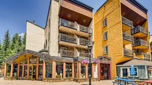 A multi-story building with balconies, a storefront labeled "Jewelers," and outdoor seating. - Lift House Lodge, Pet Friendly, Premium Studio Condo (Vail)