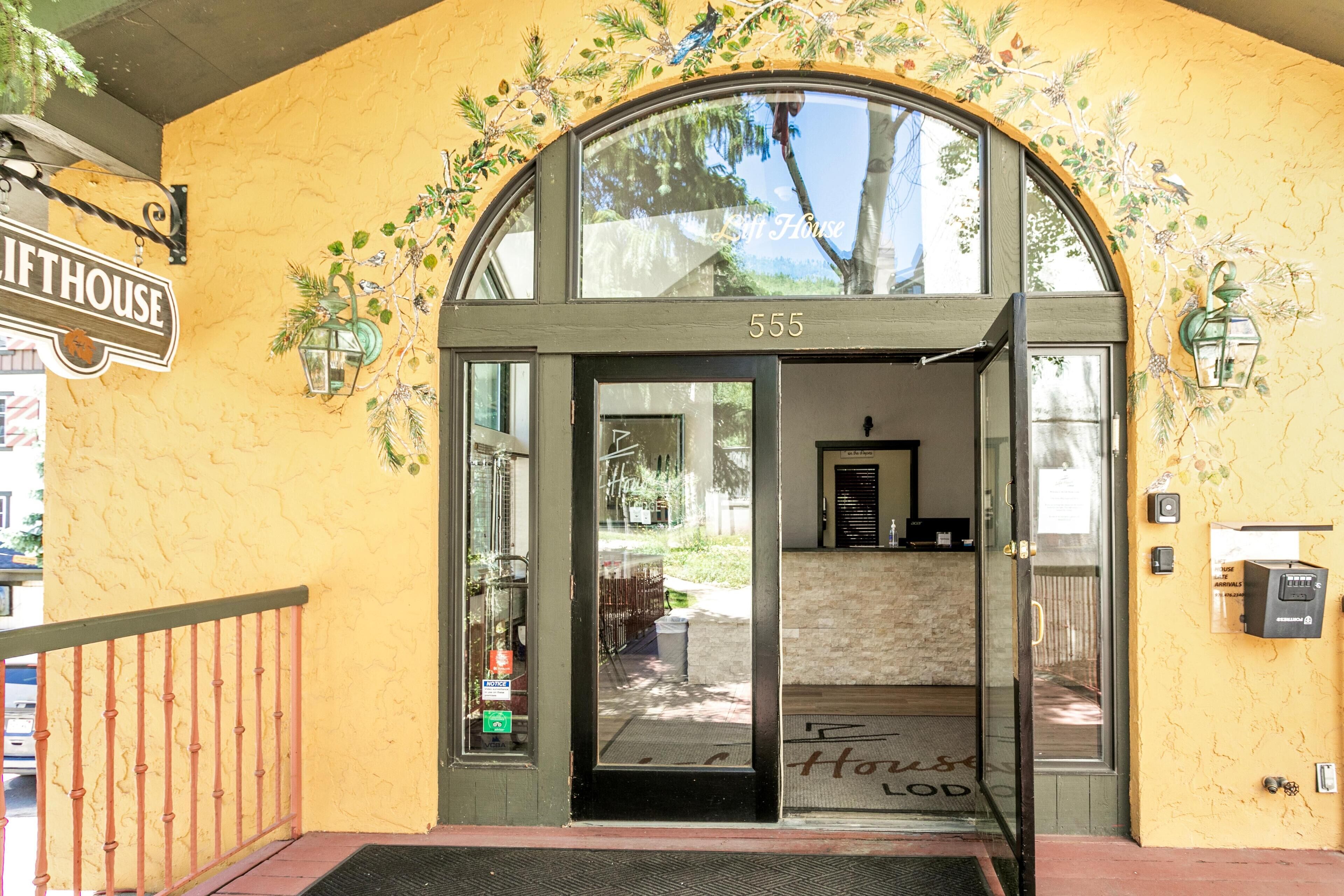 A building entrance with a sign reading "Lifthouse 555" and a glass door leading inside.