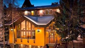 A building with a stone base, a yellow facade, and a sign reading "LITHOUSE." - Lift House Lodge, Downtown Lionshead Remodeled Studio Condo (Vail)