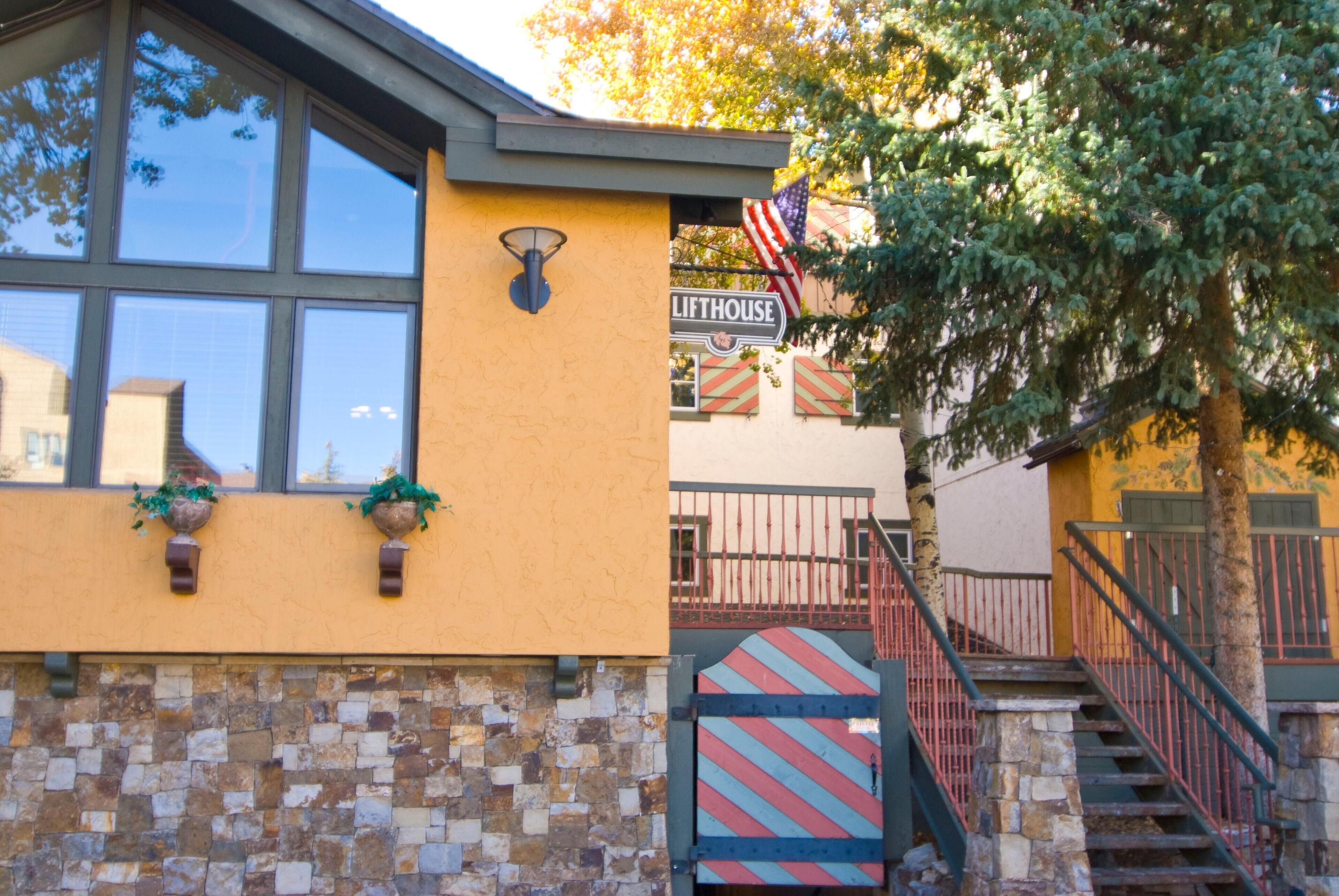 A building with a stone facade, a sign reading "LIFTHOUSE", and a flag.