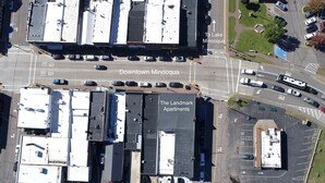 An aerial view of Downtown Minocqua with The Landmark Apartments. - Modern Rustic 2BR Condo in Downtown Minocqua—Walk to Shops, Dining & Lake (Minocqua)