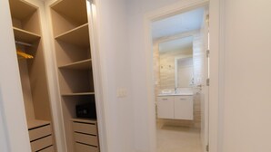 A narrow hallway leading to a bathroom with a white sink and cabinets. - PREMIUM Apartment with 3 bedrooms. Capacity for 6 people (Marbella)