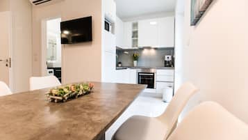 Deluxe Apartment | Living area | TV