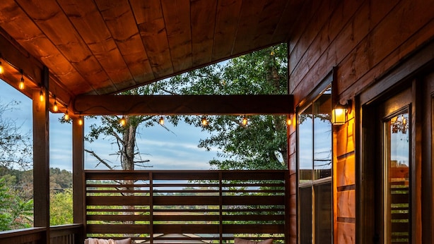 A wooden deck with wicker furniture, a fire feature, and dining set. - Planning a Smokey Mtn Family Vacation? Stay Here! They will love you for it. (Sevierville)