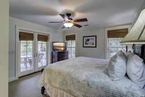 A bedroom with a bed, a ceiling fan, a television, and a picture on the wall. - 1 Roadrunner (Hilton Head Island)