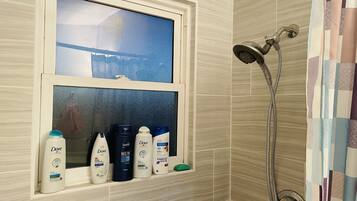 Bathtub, hair dryer, towels, soap