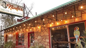 A restaurant with a stone facade, a red door, and string lights. - Central Houston - Bright and Spacious Modern Mid - 4 miles to DT (Houston)