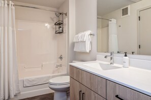 Traditional Apartment, 1 Bedroom (Self Check-in with Virtual Front Desk) | Bathroom | Combined shower/tub, free toiletries, hair dryer, towels