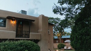 A house with a patio area featuring outdoor seating and a small fire pit.