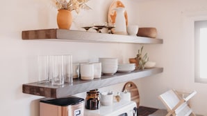 A kitchen with a coffee maker, a microwave, and a bread loaf on a shelf. - Hot Tub + Pool! Coyote Suite at The Desert Compass in Old Town (Albuquerque)