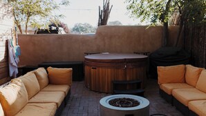 An outdoor seating area with a round table and two sofas. - Group Gatherings ☀ Property Buyout at The Desert Compass (Albuquerque)