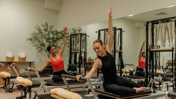 A Pilates studio with equipment and mirrors.